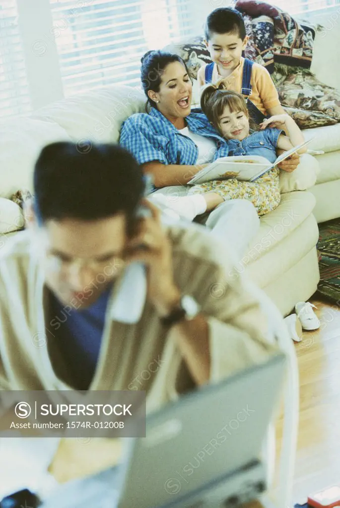 Mother sitting on the couch with her son and daughter