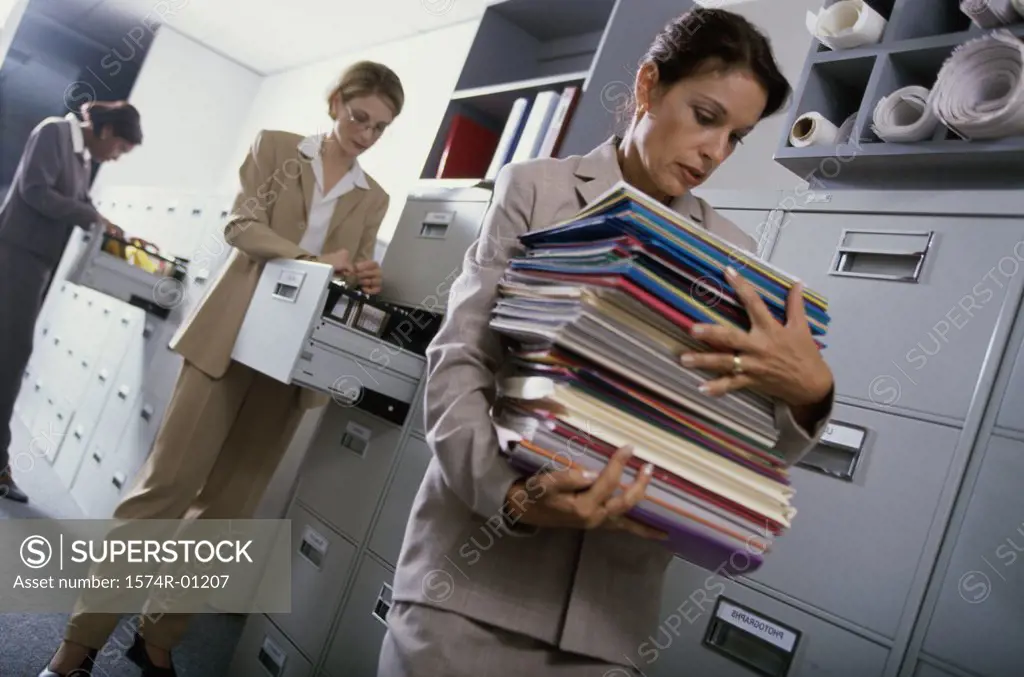 Businesswoman carrying a stack of files