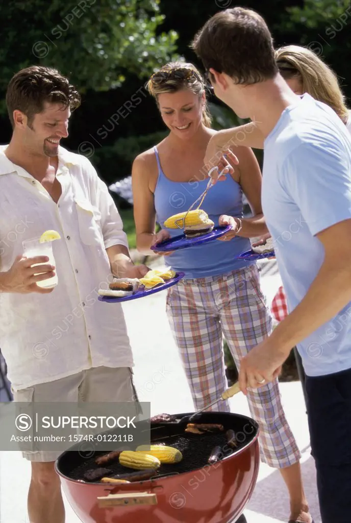 Two young couples at a barbecue