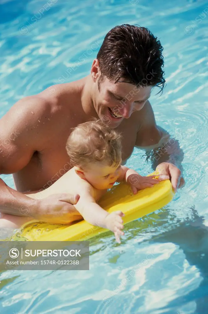 Father in a swimming pool with his baby boy