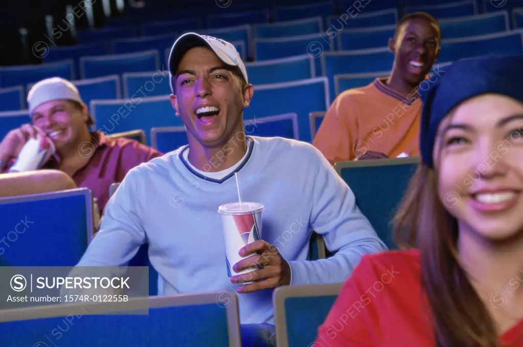 Four teenagers sitting in a movie theater
