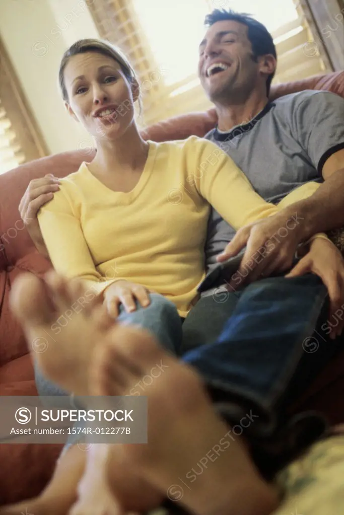 Mid adult couple watching television