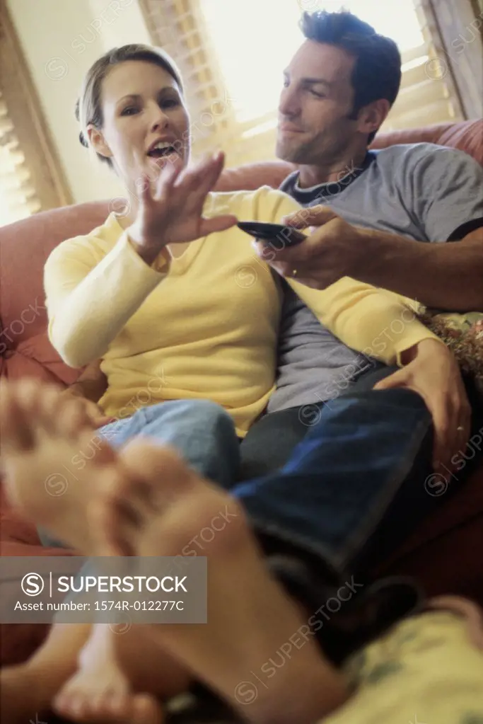 Mid adult couple watching television