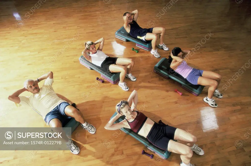 High angle view of a group of people exercising in a step aerobics class