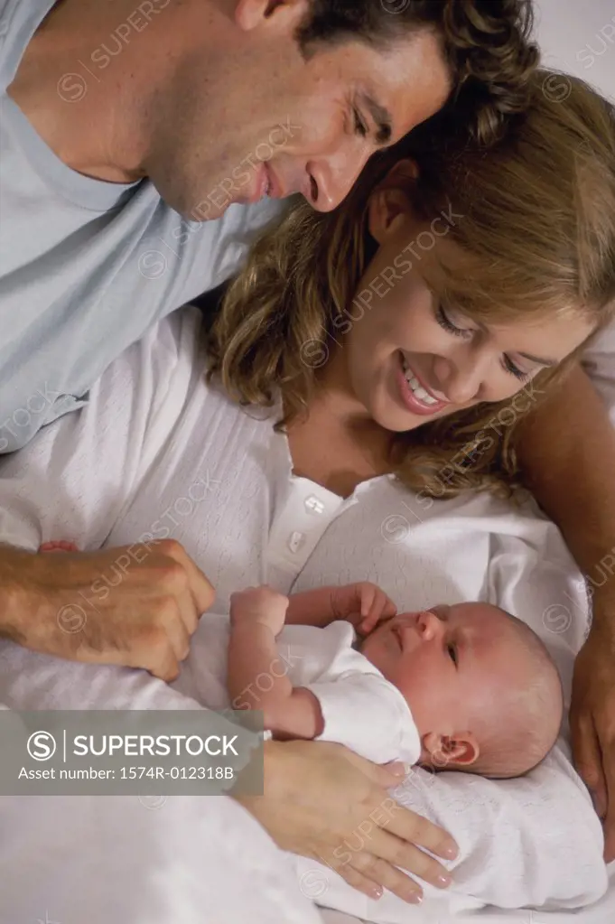 Close-up of parents looking at their son and smiling