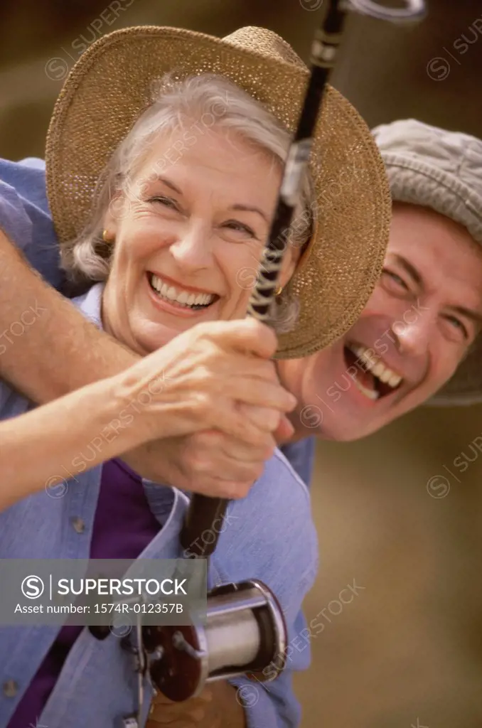Close-up of a senior couple holding a fishing rod