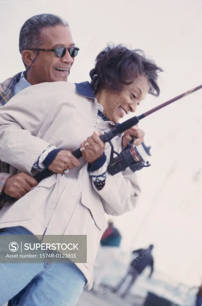 Low angle view of a mature couple fishing together