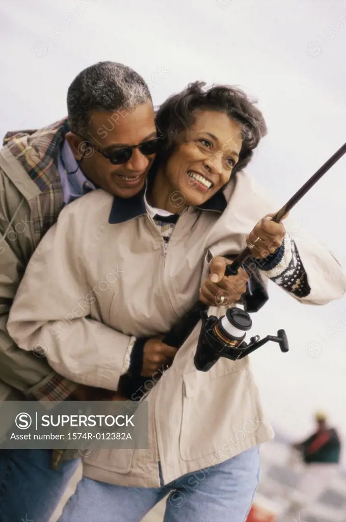 Mature couple holding a fishing rod