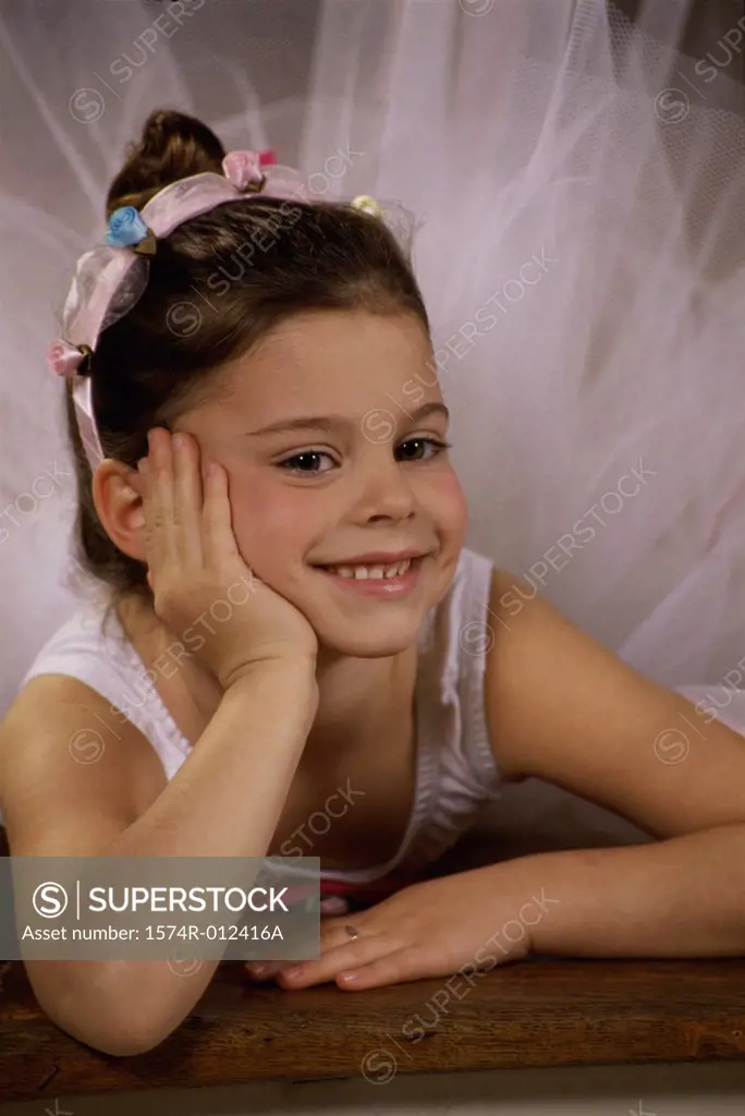 Close-up of a ballerina smiling with her hand on her chin