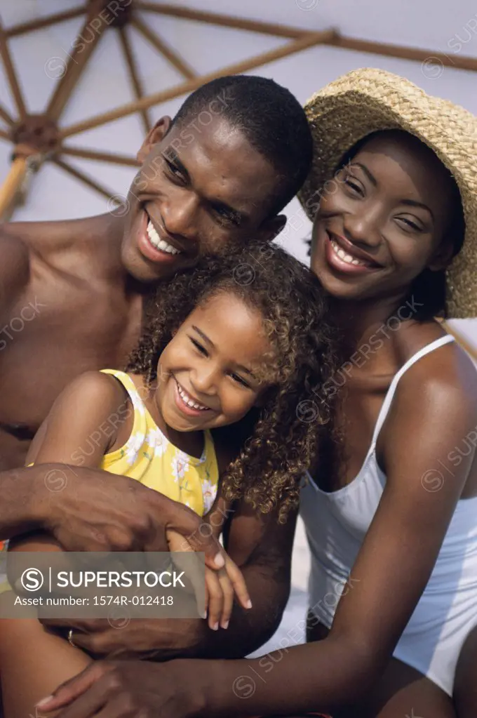 Close-up of parents and their daughter smiling
