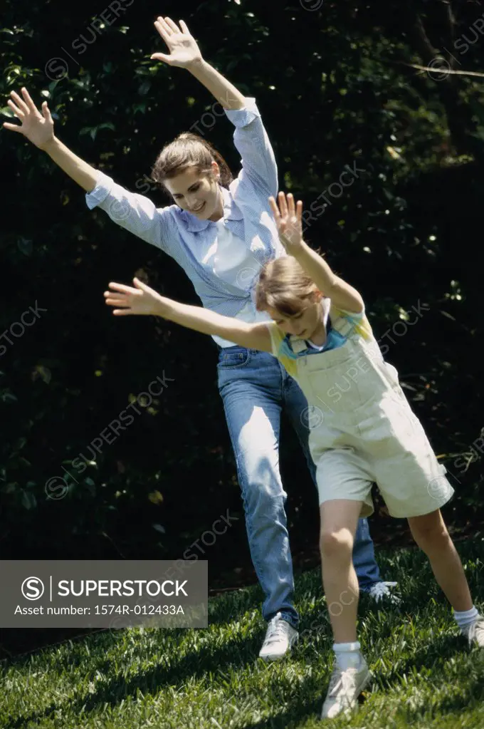 Mother and daughter exercising in a garden