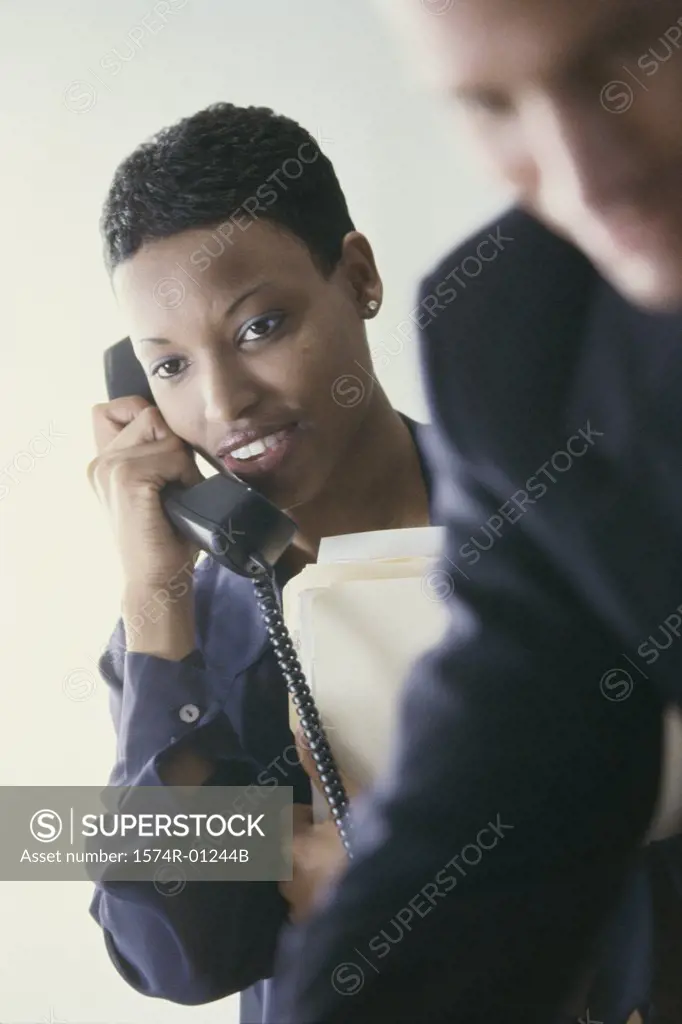 Businesswoman talking on a landline telephone