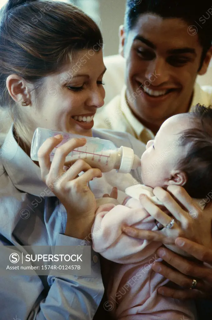 Close-up of parents feeding their son