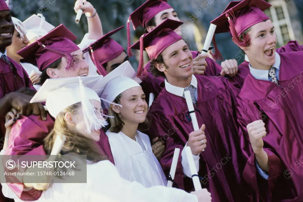 Group of teenage graduates celebrating