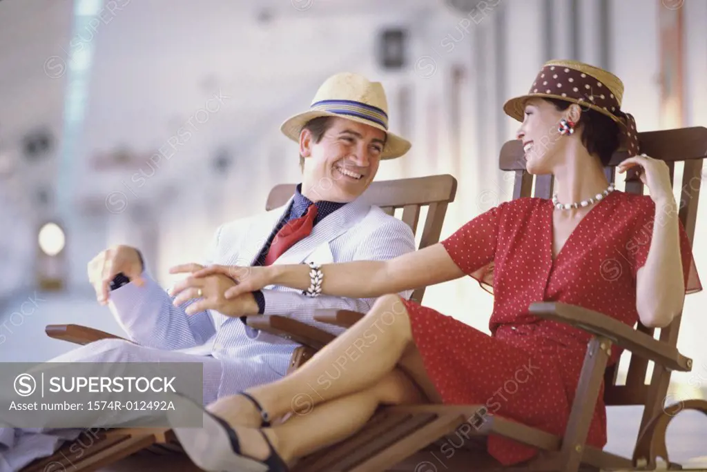 Close-up of a young couple sitting on a cruise ship and smiling