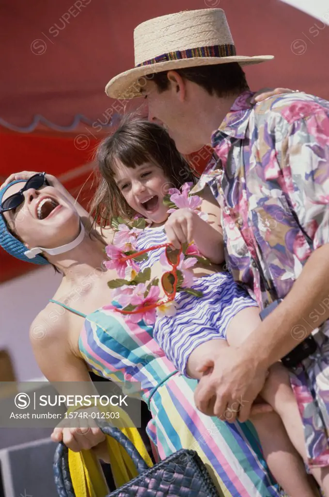 Low angle view of a mid adult couple laughing with their daughter