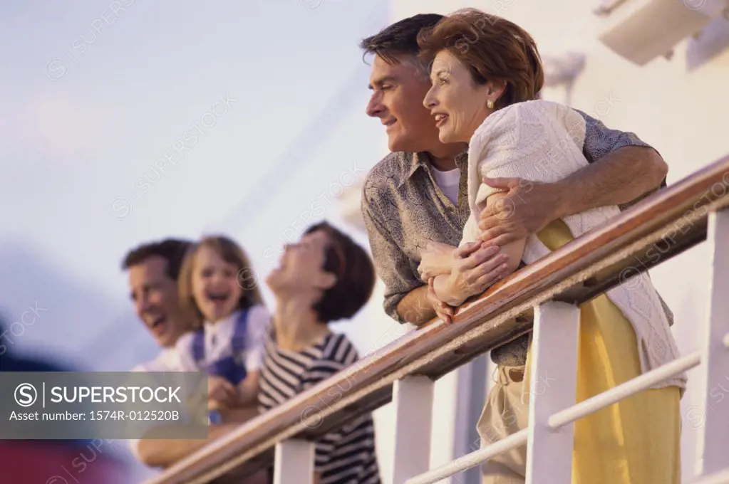Side profile of a mature couple standing on the deck of a cruise ship