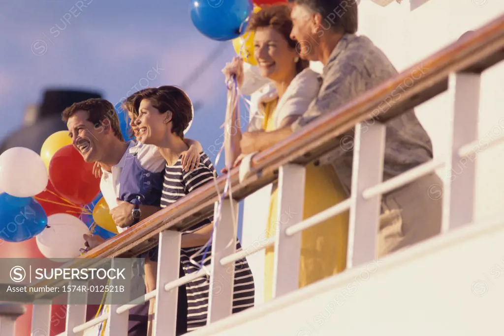Low angle view of five people standing on the deck of a cruise ship