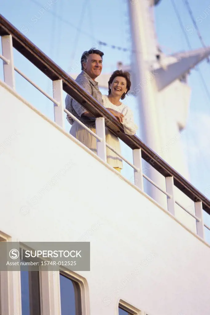 Low angle view of a mature couple standing on the deck of a cruise ship