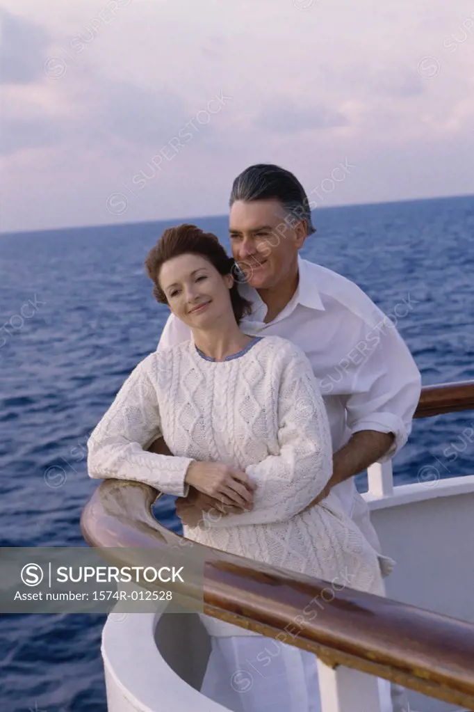 Mature couple standing on the deck of a cruise ship