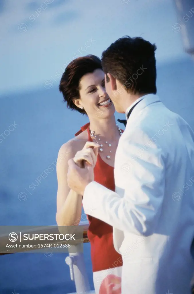Young couple dancing on the deck of a cruise ship