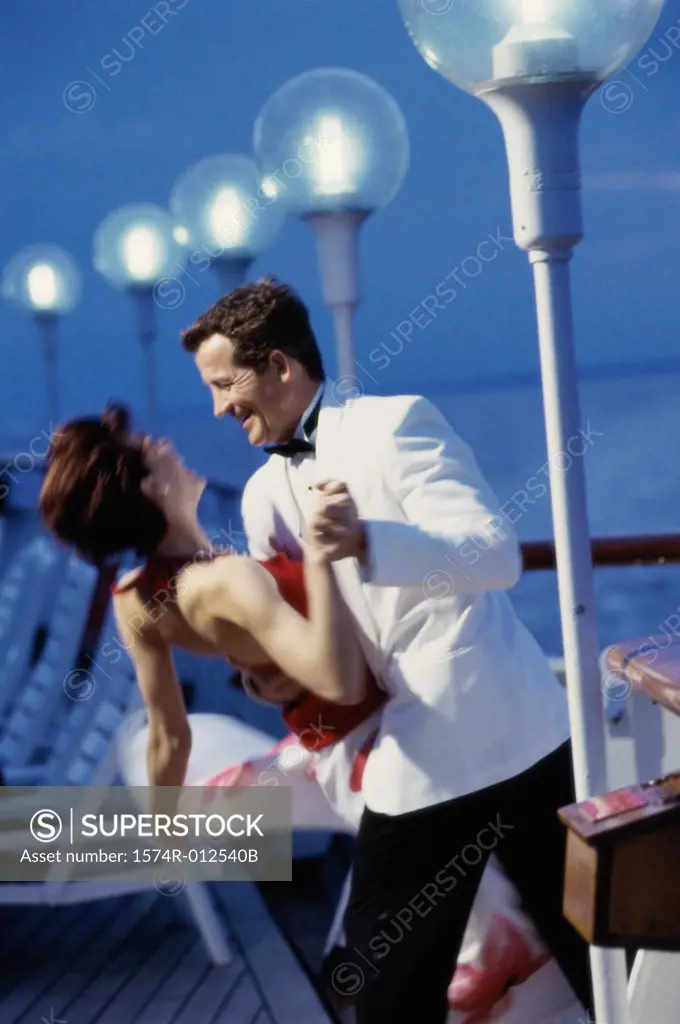 Side profile of a young couple dancing on a cruise ship
