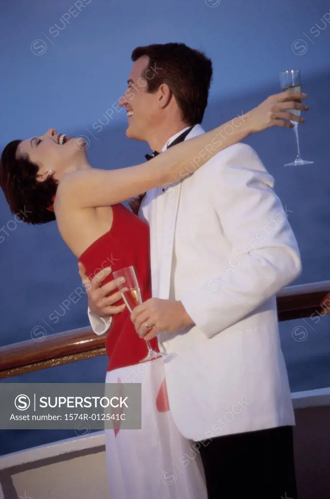Side profile of a young couple embracing each other on a cruise ship