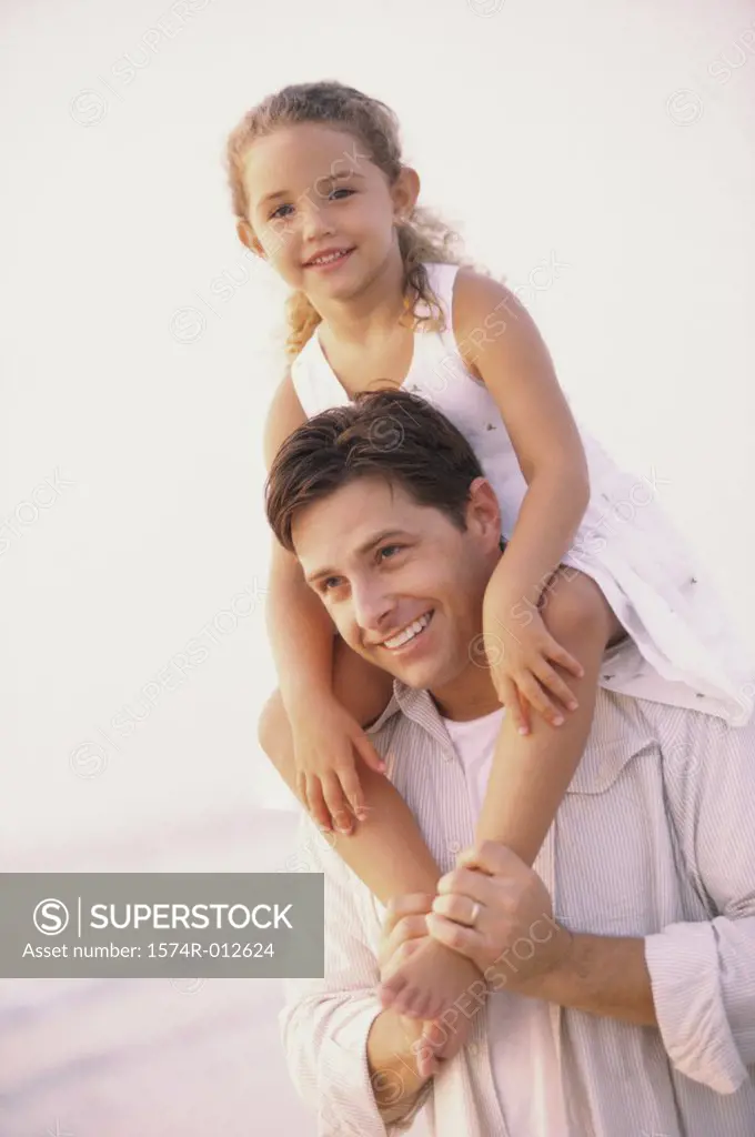 Father carrying his daughter on his shoulders