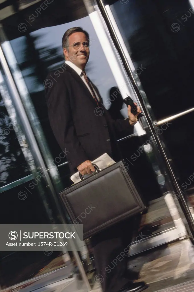 Portrait of a businessman standing at a doorway smiling