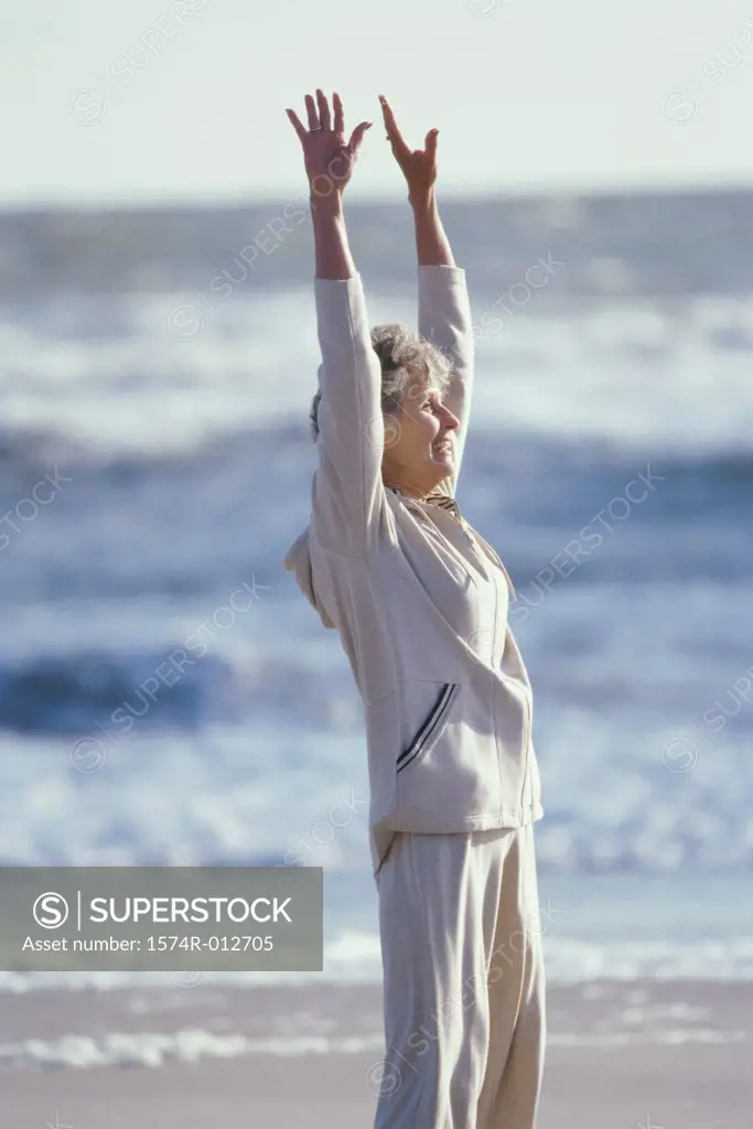 Side profile of a senior woman exercising on the beach