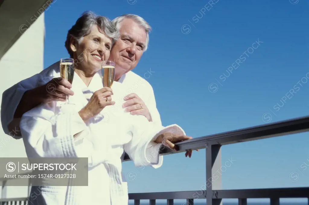 Senior couple holding champagne flutes