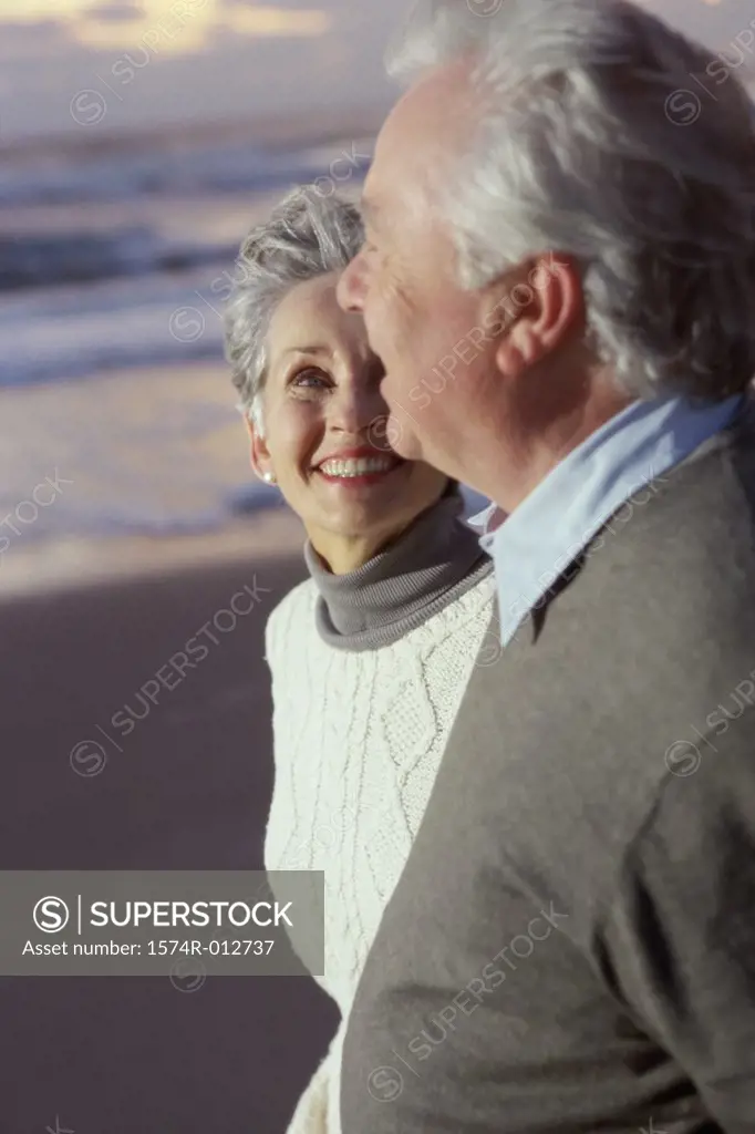 Close-up of a senior couple standing on the beach