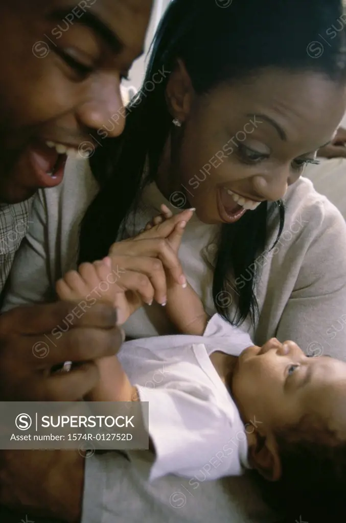 Close-up of parents holding their son
