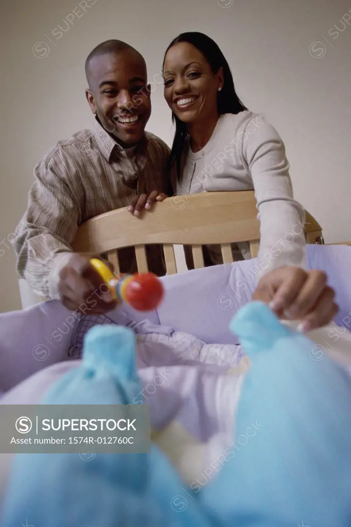 Close-up of parents looking at their son in a crib