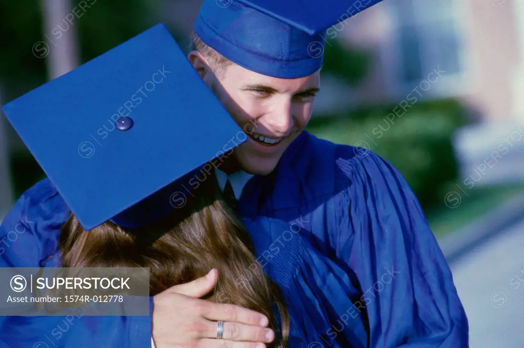 Rear view of a young graduate couple congratulating each other