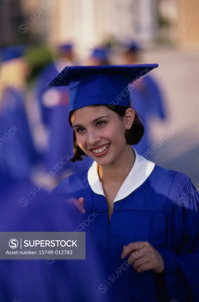 Female teenage graduate smiling