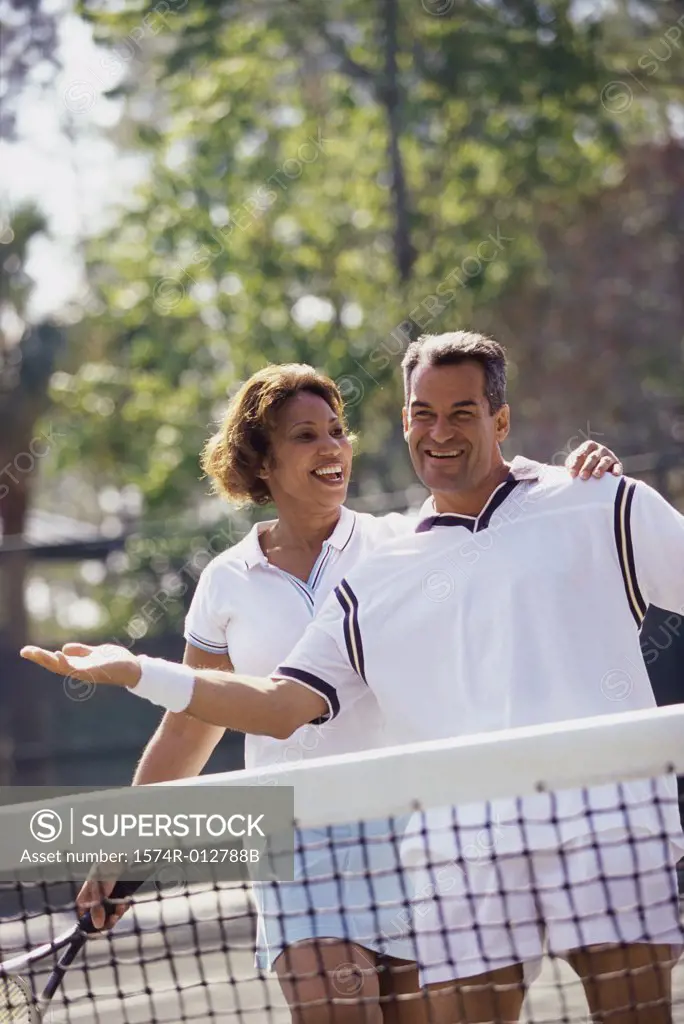 Mid adult couple playing tennis