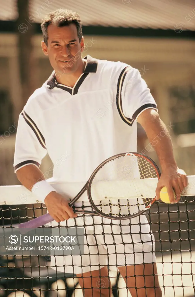Portrait of a mid adult man standing on a tennis court