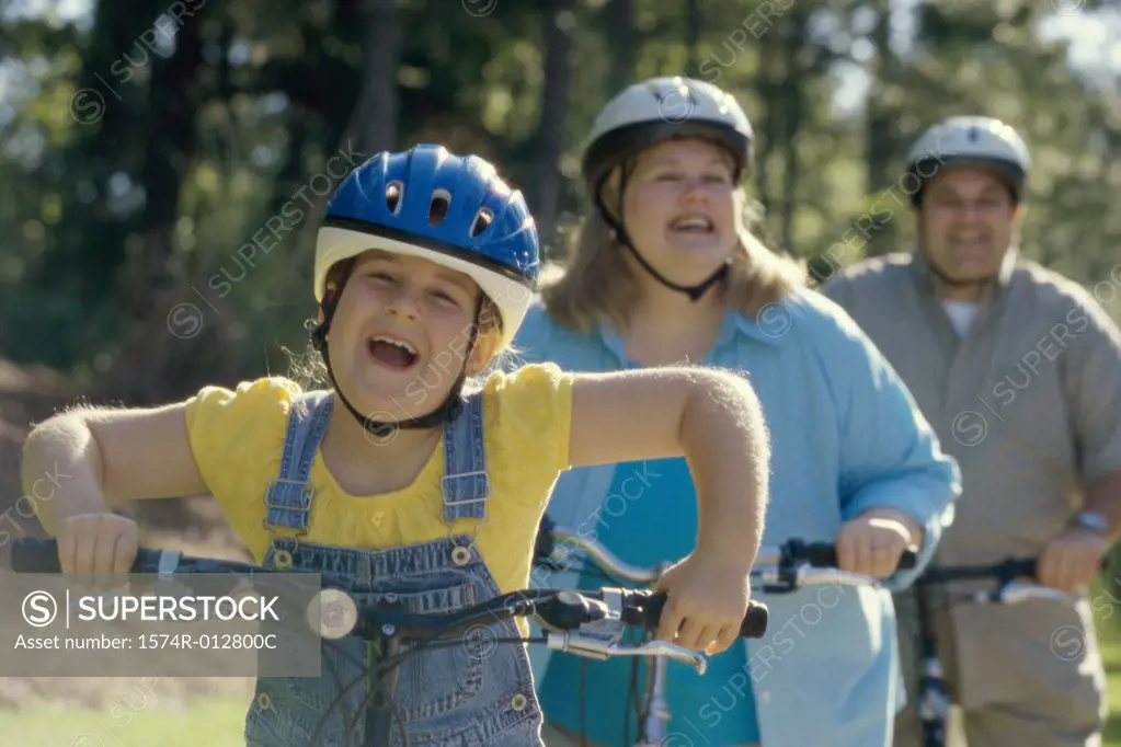 Daughter cycling with her parents