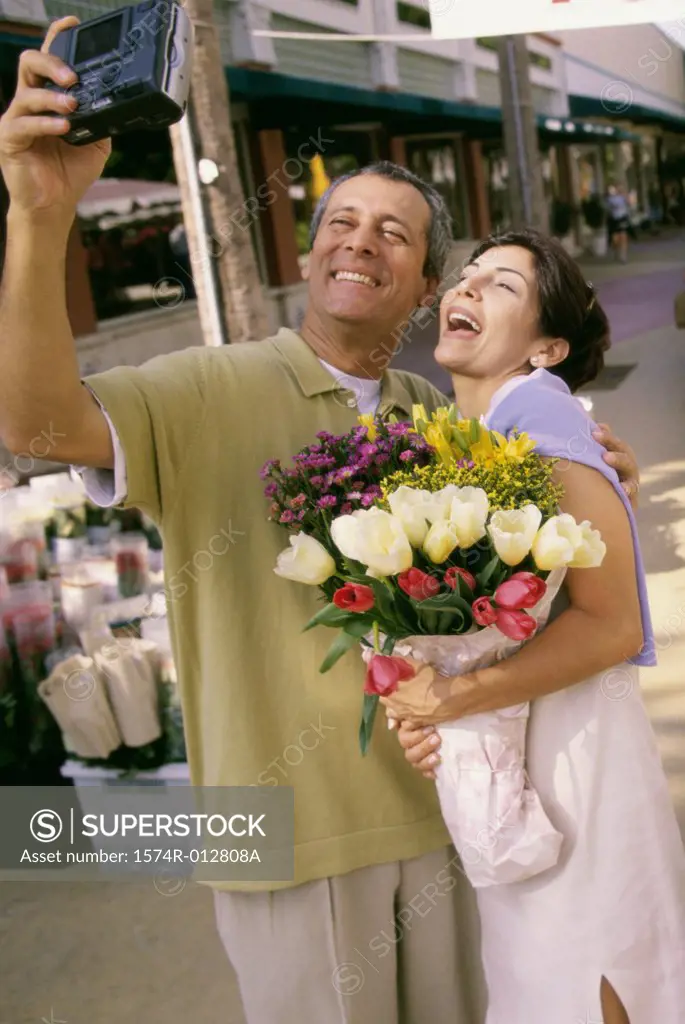 Mature couple taking a photograph of themselves
