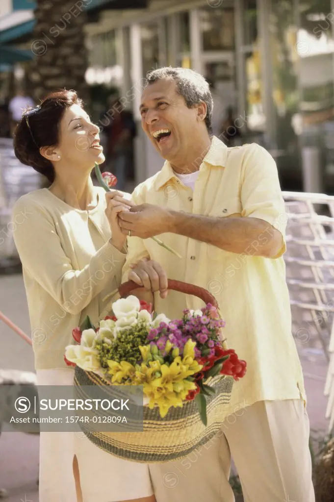 Mature man giving a flower to a mature woman