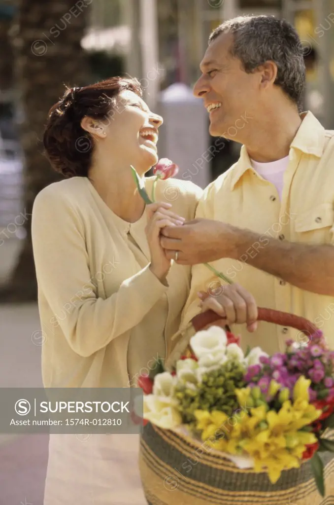 Mature man giving a flower to a mature woman