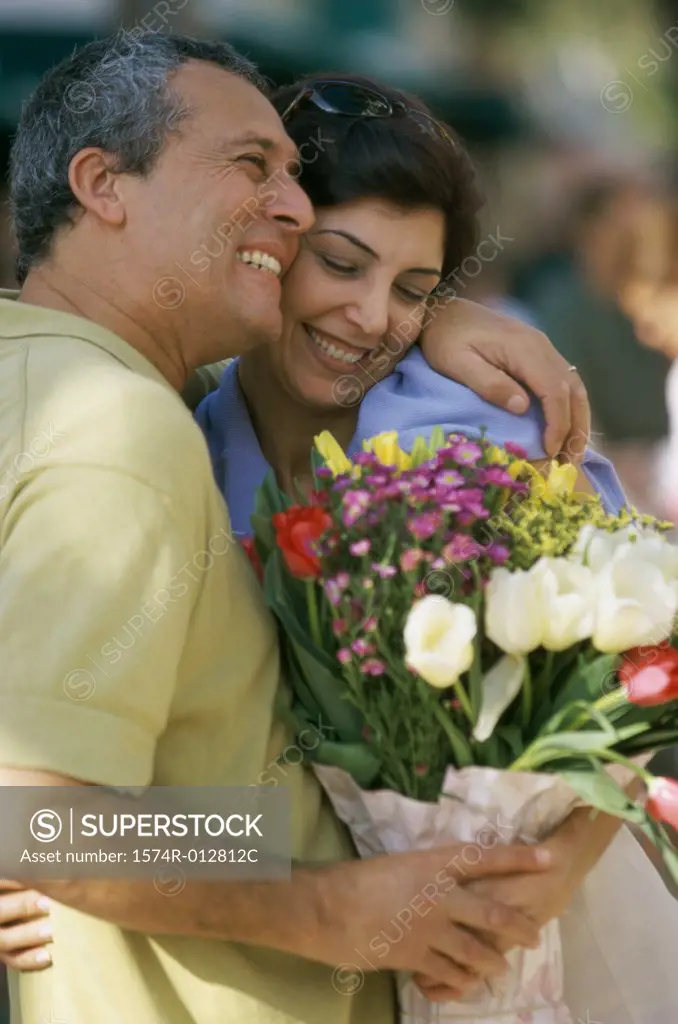 Close-up of a mid adult couple holding a bouquet of flowers