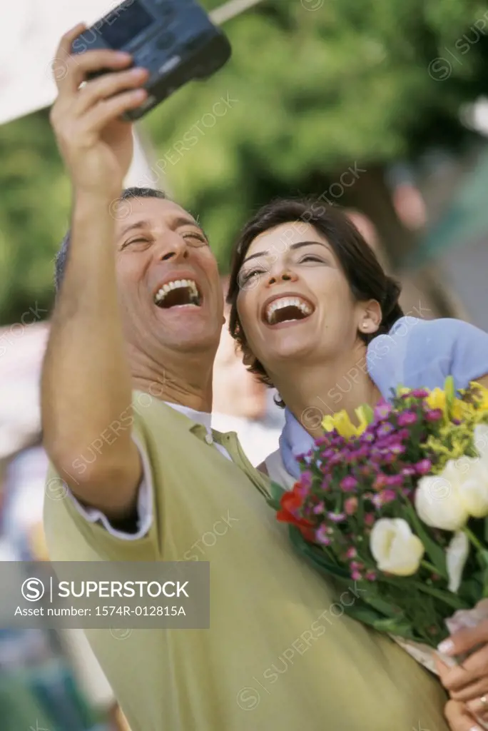 Mature couple taking a photograph of themselves