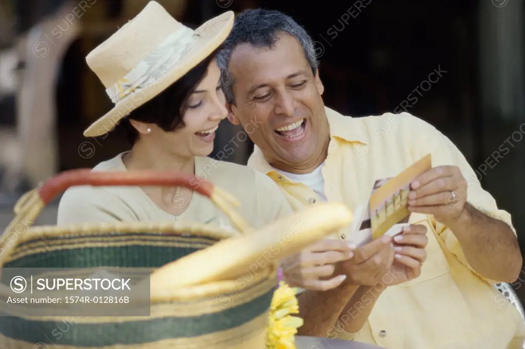 Mature couple choosing postcards