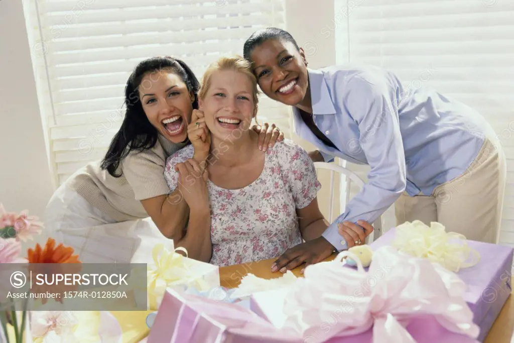 Portrait of three young women smiling at a baby shower