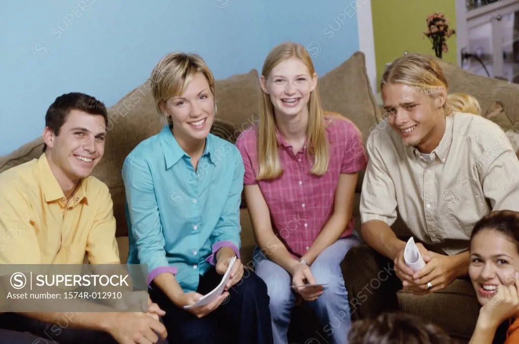 Portrait of two teenage boys and three teenage girls smiling