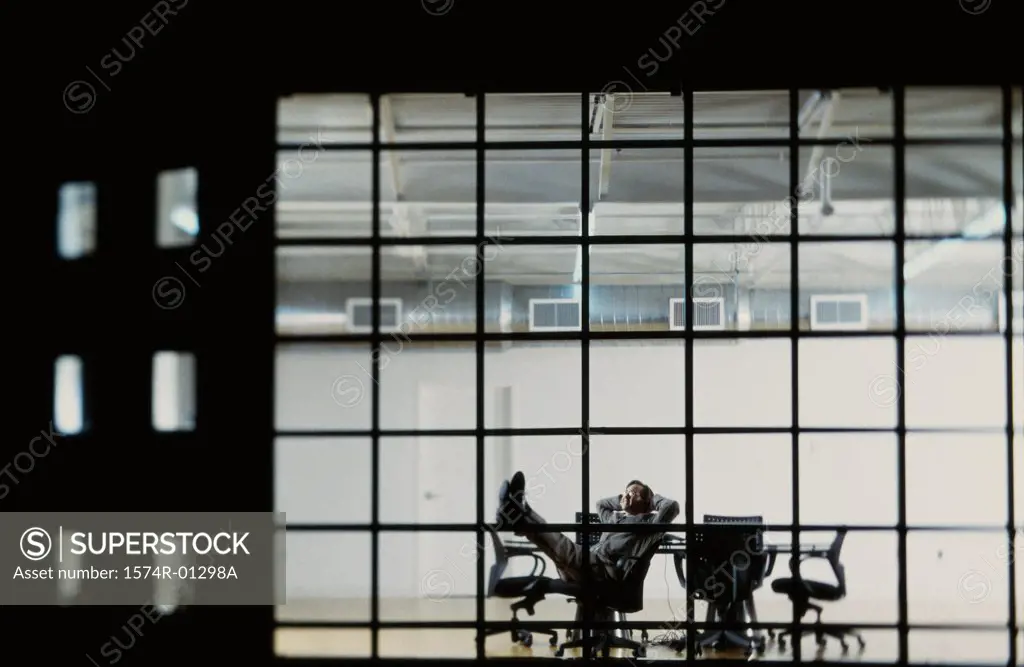 Businessman reclining in a conference room