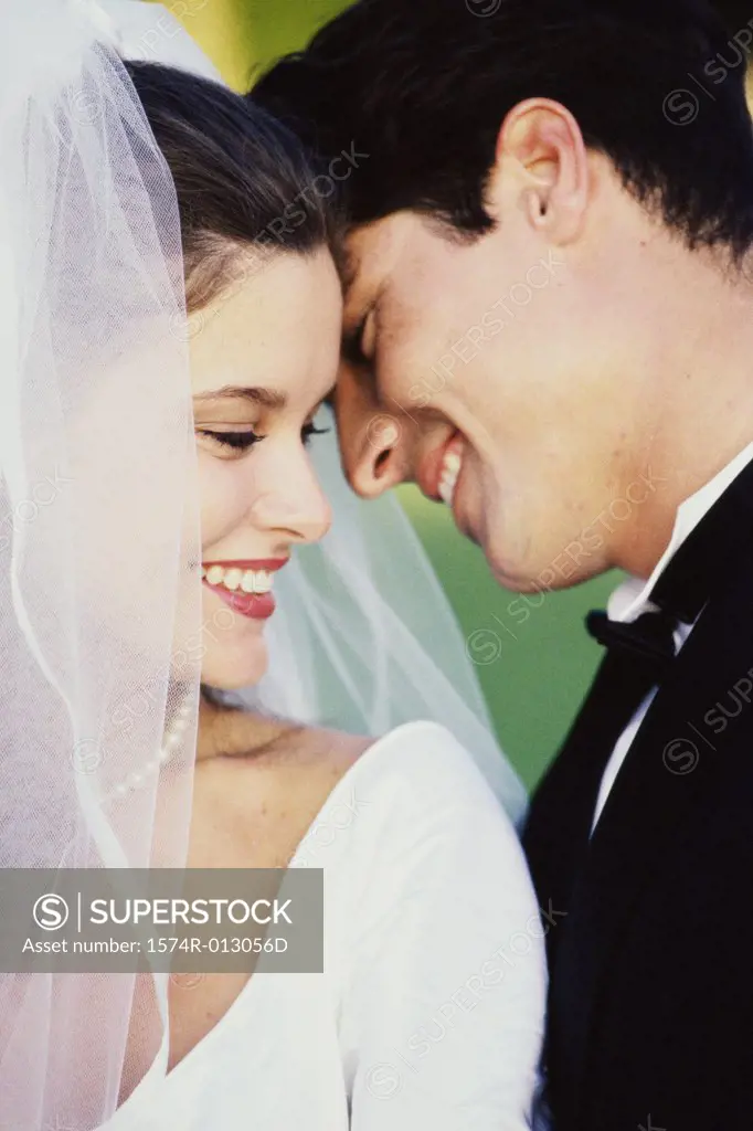 Close-up of a newlywed couple smiling