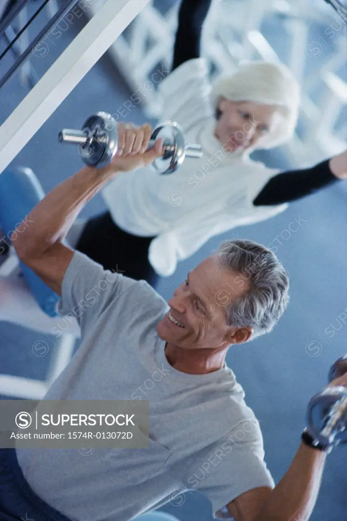 Senior couple exercising in a health club